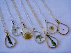 Our Large Teardrop frame is a stunning classic and available in a variety of real preserved botanicals. Choose from a 24k gold or .999 sterling silver plated finish. Baby’s Breath is a symbol of purity of heartDaisy is a symbol of hopeLavender: is a symbol of devotion and virtueAlyssum is a symbol of beautyThe Mustard Seed is a symbol of faithThe Fern is a symbol of sincerityThis frame is also available with a black background in our Cameo Collection here.Pendant hangs from a gold or silver plat Gold Botanical Flower Pendant Jewelry, Delicate Necklace With Pressed Flowers For Anniversary, Nature-inspired Gold Teardrop Pendant Jewelry, Nature-inspired Hypoallergenic Teardrop Jewelry, Gold Floral Jewelry With Flower Charm, Botanical Style Gold Jewelry With Flower Charm, Gold Botanical Jewelry With Flower Charm, Dainty Teardrop Nickel-free Necklace, Nature-inspired Gold Jewelry With Pressed Flowers