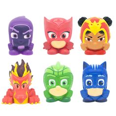 four different colored plastic toys with faces on them