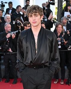 a man standing on top of a red carpet