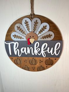 a wooden sign hanging from the side of a door that says,'thank '