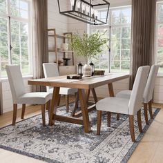 a dining room table with chairs and a rug