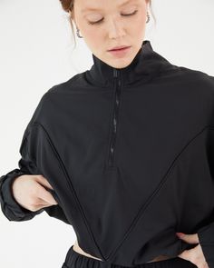 Throw it on over your favorite sports bra and leggings while you warm-up at the gym, or pair it back with the Double Take Utility Pants for a full daytime 'fit. This windbreaker is the epitome of transitional activewear. With it's exaggerated high-neck quarter zip and adjustable length feature at the hem, there's nowhere this jacket can't go. Lightweight, adjustable to be either full-length or cropped, and fully lined with the perfect performance knit fabric, the only complaint you'll have with Athleisure Activewear For Gym, High Stretch Half-zip Activewear For Gym, Black Versatile Activewear In Recycled Polyester, Recycled Polyester Sportswear Activewear For Training, Stretch Activewear For Sports With Half-zip, Stretch Half-zip Activewear For Workout, Recycled Polyester Sportswear For Training, Recycled Polyester Athleisure Activewear For Pilates, Sportswear Activewear For Gym With Half-zip