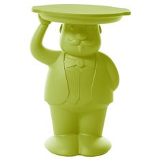 a green plastic toy with a hat on it's head