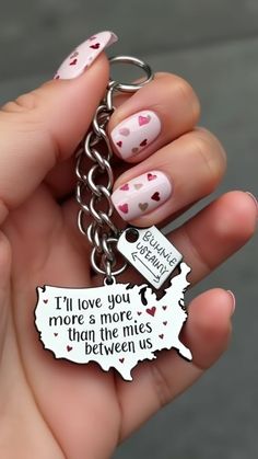 a person holding a keychain that says i'll love you more than the miles between us