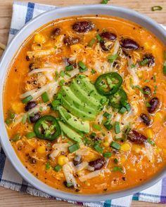 a bowl of mexican chicken soup with avocado