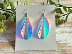 These iridescent teardrop earrings will dazzle you when the light shines through them, while a holographic rainbow will shimmer depending on the background. Holographic earrings are truly unique.  They are super lightweight and are perfect for everyday casual wear. These beauties would also be great for special occasions such as parties, dances, prom, or just a special night out. The holographic nature of these statement earrings make them a fun accessory for both teens and adults.  The nickel f Holographic Earrings, Iridescent Earrings, Earrings Prom, Prom Earrings, Iridescent Crystal, Teardrop Earrings, Handmade Earrings, Crystal Earrings, Statement Earrings