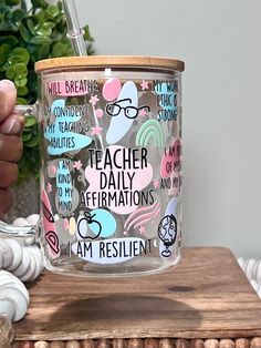 a person holding a coffee mug with teacher daily affirmations on the inside