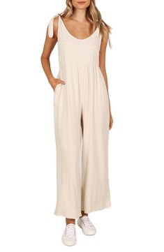 Elevate your contemporary wardrobe with this tie-shoulder linen jumpsuit finished with wide legs and handy side pockets. Pull-on style Adjustable tie straps Side-seam pockets Unlined 100% linen Hand wash, dry flat Imported Linen Jumpsuit For The Beach, Cotton Jumpsuits And Rompers With Tie Straps For Vacation, Cotton Jumpsuit With Tie Straps For Vacation, Linen Jumpsuits And Rompers For Summer, Solid Color Linen Jumpsuits And Rompers For Summer, Casual Solid Color Jumpsuits And Rompers With Tie Back, Casual Jumpsuits And Rompers With Tie Back, Casual Solid Color Jumpsuits With Tie Back, Beige Linen Casual Jumpsuits And Rompers