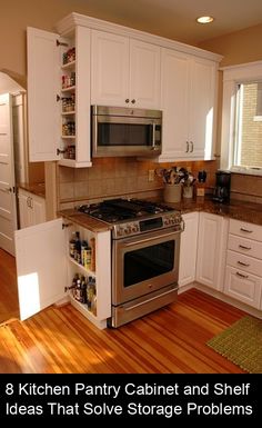 a kitchen with white cabinets and stainless steel stove top oven in the middle of it