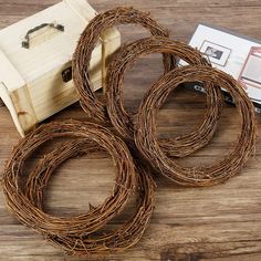 four pieces of wicker sitting on top of a wooden table next to a box