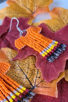 the beaded autumn leaf earrings are made with orange and yellow seed beads, which have been sewn together