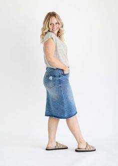 The Tiana Distressed Denim Midi Skirt is a modest and cute denim midi skirt! Designed with backed distressing at the front and back pockets, an uneven raw hem, 5 pockets for holding all the things, and a classic button zipper closure. Style: distressed, denim, midi length Color: Denim Quality control is of the utmost importance to us. Our sizing is always approximate and can also depend heavily on your own body shape. Just like no two people are the same, the same goes for skirts, dresses + tops Casual Medium Wash Denim Midi Skirt, Spring Denim Skirt In Dark Wash With Unfinished Hem, Casual Medium Wash Knee-length Denim Skirt, Medium Wash Denim Skirt With Unfinished Hem, Spring Dark Wash Denim Skirt With Unfinished Hem, Casual Knee-length Medium Wash Denim Skirt, Mid-rise Medium Wash Denim Skirt With Frayed Hem, Knee-length Medium Wash Bottoms With Frayed Hem, Knee-length Denim Blue Skirt With Frayed Hem