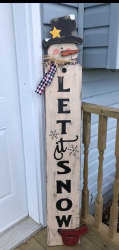 a wooden sign with the word snow written on it and a cowboy's hat