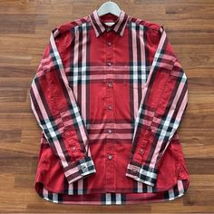 Burberry Brit Stretch Cotton Plaid Check Long Sleeve Men’s Shirt In Red Color Condition: Very Good, No Defects, Light Wear Throughout Chest Patch Pocket Made From 66% Cotton / 30% Polyamid / 4% Elasthan Size: Medium Approximate Armpit To Armpit: 21.5 Inches Approximate Back Collar To Hem: 30.8 Inches Designer Long Sleeve Red Top, Designer Red Long Sleeve Tops, Designer Fitted Red Shirt, Designer Red Fitted Shirt, Red Cotton Shirt With Spread Collar, Designer Red Tops For Fall, Designer Red Long Sleeve Shirt, Burberry Shirts, Long Sleeve Men