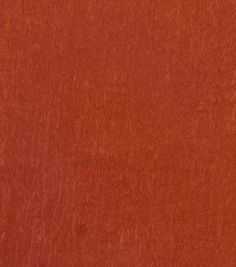 a close up view of an orange colored fabric textured with some sort of stain