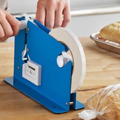 a person is using a machine to make bread