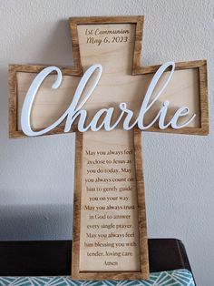 a wooden cross with the word charlie written on it