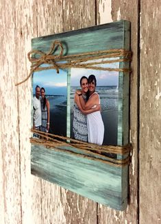 an old wooden frame with two photos hanging on it's side and rope around the edges