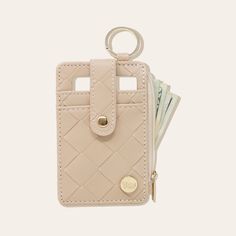 a wallet with money sticking out of it and a keychain hanging from the front