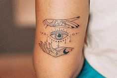 a woman's arm with an all seeing tattoo on it