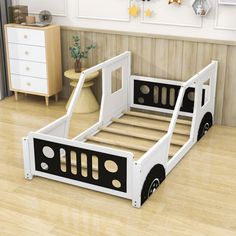 a child's bed with black and white bedspread