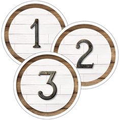 three wooden numbers are shown in the shape of two circles with one number on each side