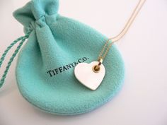 Overview:Everyone needs a signature Tiffany piece! Here is the perfect one just for you - and it's a very rare and special limited edition! Offered for sale is a wonderful Tiffany & Co. 18K Gold and Mother of Pearl Double Heart necklace. Hanging from its gorgeous 18K Gold Tiffany curb chain is an 18K Gold "smaller" Heart from where the fabulous Mother of Pearl Heart hangs from. Beautiful and just awesome Tiffany piece! It is just like wearing a piece of art on your neck - without the super h Pearl Heart Necklace, Gold Tiffany, Double Heart Necklace, Pearl Heart, Gift Love, Double Heart, Small Heart, Charm Gift, Curb Chain