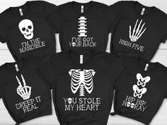 Family Skeleton Costume, Black Halloween T-Shirt, Matching Group / Work / Office Outfit, Adult / Teen / Youth Size Tee, Unisex Fall Clothing A classic cotton tee made with an extremely soft preshrunk cotton. The graphic is digitally printed on top of the cotton to produce a vivid garment with a soft hand feel. Adult Unisex Size Guide: Unsure what size to order? Always order a size up if unsure. We pride ourselves in offering a wide array of product types and size runs in order to be inclusive to the widest array of body types. Ultimately sizing can be a very subjective thing and for that reason it's important that the sizing instructions are followed carefully. Please read entire listing description before purchasing your item. (XS) W= 17.5" L= 27" (S) W= 19" L= 28" (M) W= 20.5" L= 29" (L) Black Stretch T-shirt For Halloween, Stretch Halloween T-shirt With Graphic Print, Halloween Stretch T-shirt With Graphic Print, Black Horror Tops With Skull Print, Black Horror Screen Print Tops, Black Band Merch Tops For Halloween, Black Band Merch Top For Halloween, Black Horror T-shirt With Skull Print, Horror Black T-shirt With Skull Print