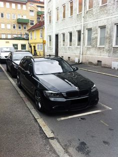 a black car parked on the side of a street