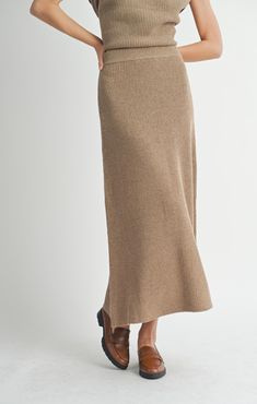 Get ready to jazz up your fall wardrobe with the Crosby Sweater Midi Skirt! This beautiful dark taupe skirt is perfect for those chilly autumn days, with its midi length and cozy sweater material. The elastic waist ensures a comfortable fit, while the ribbed detailing adds a touch of texture. It's a must-have for any fashion-forward individual! Midi length Ribbed knit 100% polyester Midi Sweater Skirt, Ribbed Knit Fabric, Shady Lady, Aline Skirt, Dark Taupe, Vintage Havana, Sweater Material, Dress Romper, Sweater Blouse