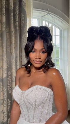 a woman in a wedding dress posing for the camera