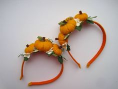 two orange headbands with leaves and pumpkins on them