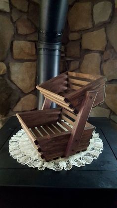 a wooden crate sitting on top of a table next to a wood fire place cover