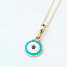 Tiny 14k solid gold round evil eye  pendant with enamel -Blue evil eye with white and black center. -The 14k solid gold chain is available in 3 different lengths, please make your choice from the drop down menu.  -Size: 8mm / 1/3 inch . -Perfect gift for Valentine or any other special occasion. Comes in a gift box. 14k Gold Charm Necklace With Evil Eye, 14k Gold Round Evil Eye Charm Necklace, 14k Gold Evil Eye Charm Necklace With Round Pendant, Yellow Gold Evil Eye Charm Necklace, Round Evil Eye, Solid Gold Chains, Luck Charm, Blue Evil Eye, Eye Pendant