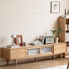 a living room with an entertainment center and bookshelf