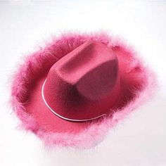 a red hat with pink fur around it on a white surface, viewed from above