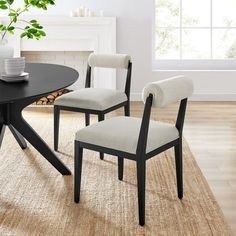 a black table with two chairs and a white chair in front of it on top of a rug