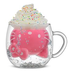 a hello kitty cupcake with sprinkles and frosting on top in a glass mug