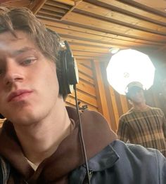 a young man wearing headphones in a recording studio