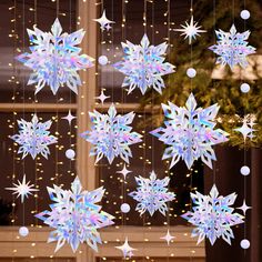 snowflakes hanging from the side of a window