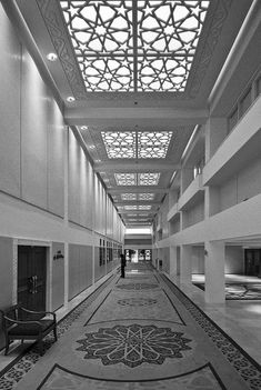 the inside of a large building with an intricate ceiling and carpeted flooring in black and white