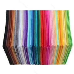 an assortment of colored papers are arranged in rows on top of each other, with one folded