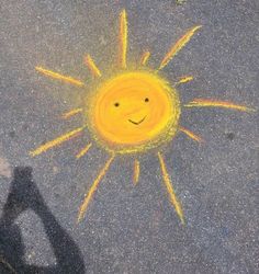 a yellow smiley face drawn on the pavement