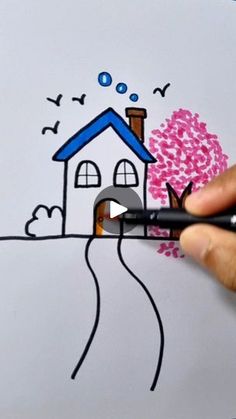 someone is drawing a house with colored pencils