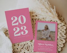 two pink and white birthday cards on a doily