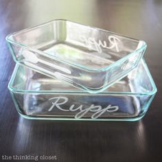 two glass dishes sitting on top of a wooden table next to each other with the words rupp written on them