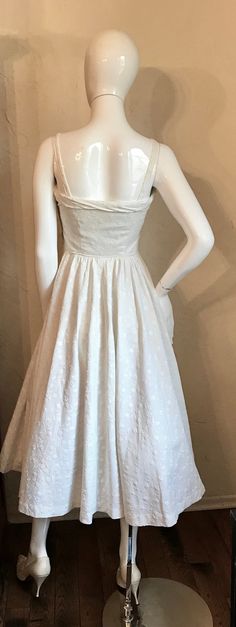 "Here is a pretty 1950's dress set. The fabric is a white embroidered matelasse heavy cotton. The dress is a fit and flare sun dress, with fitted bodice, shoulder straps and full gathered skirt and has a side metal zipper. It has the matching bolero jacket. Condition is good ...a couple of tiny stains on back of jacket and some yellowing at bust of dress Tag - n/a Measurements lying flat: Bust 16\", Waist 12\", Hips Free, Length 47\",' shoulder to waist 15\" Mannequin is 34-25-36..." White Vintage Dress With Fitted Bodice For Spring, White A-line Vintage Cotton Dress, White Cotton 1950s Style Dress, 1950s White Sleeveless Dress, 1950s Style White Sleeveless Dress, Vintage White Dress With Sweetheart Neckline, White Vintage Dress With Sweetheart Neckline, 1950s White Cotton Dress, Fitted White Vintage Dress In 1950s Style