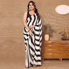 Black & White colored saree is made from georgette fabric which is highlighted with printed & lace border work as shown. comes along with banglori silk blouse piece which you can customise as per your design/style. Occasion - You can wear this saree for parties, functions and events. Note:- the actual product may differ slightly in color and design from the one illustrated in the images when compared with computer or mobile screen. Measurements: Saree : Georgette : 5.5 Mtrs Blouse : Georgette : Party Dupatta In Georgette With Digital Print, Navratri Georgette Saree With Digital Print, Black Blouse With Sheer Dupatta For Navratri, Black Sheer Dupatta Blouse For Navratri, Semi-stitched Georgette Blouse Piece With Border, Party Dupatta With Printed Border In Georgette, Diwali Black Georgette Pre-draped Saree, Black Saree With Printed Border For Navratri, Party Saree With Digital Print In Traditional Drape