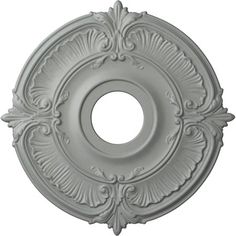 a white ceiling medallion with an ornate design