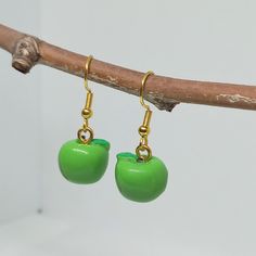 Cute and original dangle fruit earrings.   Kawaii green apple earrings  Resin apples with stainless steel hypoallergenic hooks.  Silver and golden steel hooks available A very original gift for fruit lovers, for veggies and vegans. *Measures 1.2 x 1.4cms  Total drop length: 3cms  Weight: 1.9g These earrings are carefully shipped in a cardboard box to guarantee you will receive them in perfect conditions. Please specify if you want them as a gift when you are ordering. No additional cost The packaging used in shipments is handmade with recyclable and sustainable materials.  I don't use plastic.  #appleearrings #kawaiiearrings #fruitearrings #originalearrings #originalgift #stainlesssteelhooks #hypoallergenicearrings #everydayearrings #summerearrings #greenearrings #applejewelry #originalgif Green Fun Earrings For Gift, Green Fun Earrings For Gifts, Fun Green Earrings For Gifts, Fun Green Earrings For Gifting, Cute Adjustable Green Earrings, Green Dangle Earrings With Fun Style, Trendy Green Jewelry With Fruit Design, Green Novelty Dangle Earrings, Green Novelty Dangle Jewelry